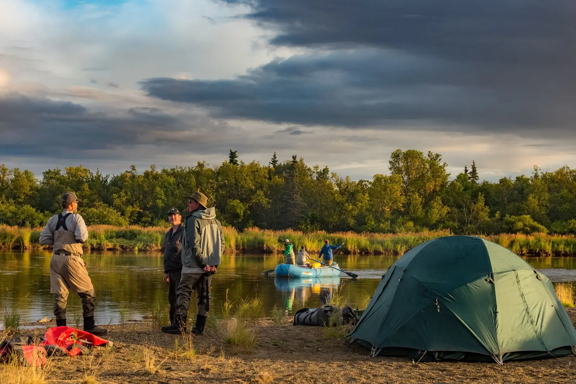 People by river with camping gear - Intricate Bay Outpost